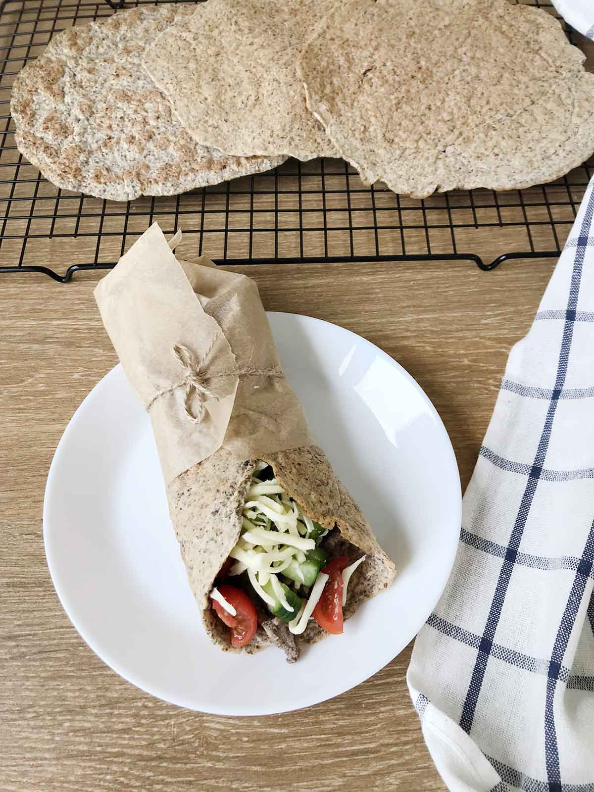 keto tortilla wrap full of tomatoes, cheese and beef.