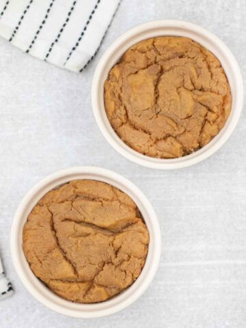 2 eggless peanut butter microwave cookies in ramekins.