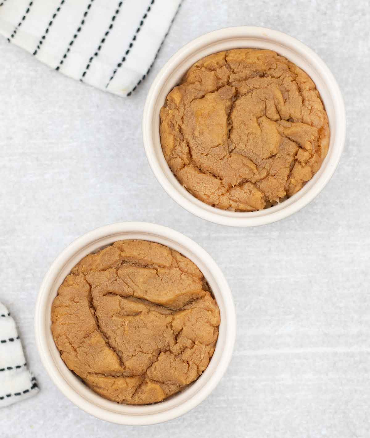 2 eggless peanut butter microwave cookies in ramekins.