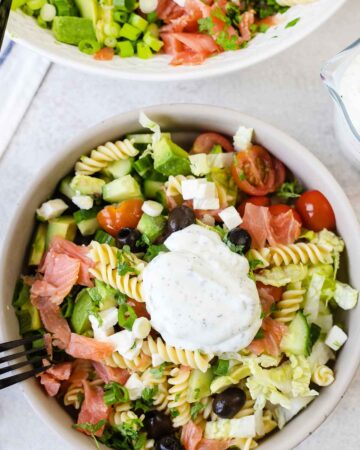 smoked salmon pasta salad topped with creamy salad dressing.