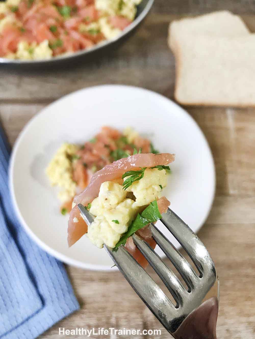 A forkful of smoked salmon scrambled eggs.