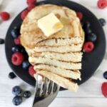 Sugar-free pancakes topped with butter and some berries.