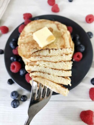 Sugar-free pancakes topped with butter and some berries.