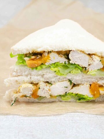 Coronation chicken sandwich cut in half.