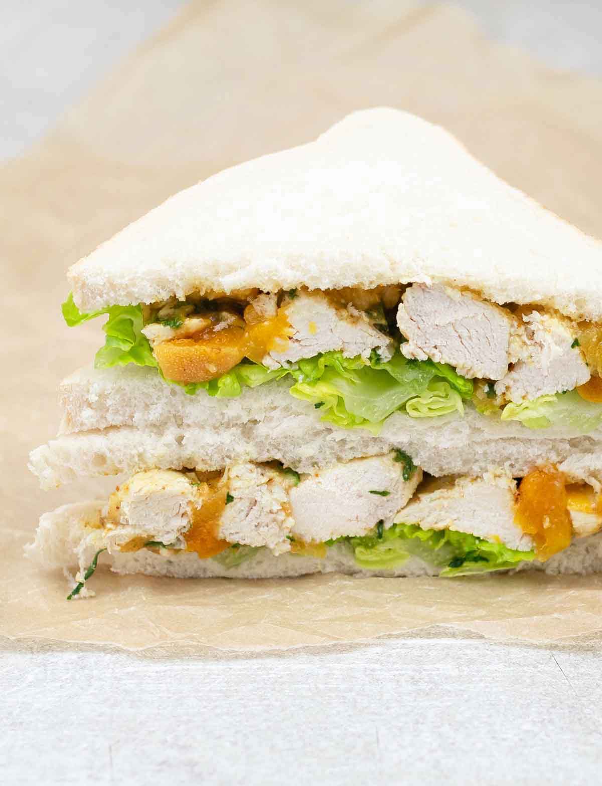 Coronation chicken sandwich cut in half.