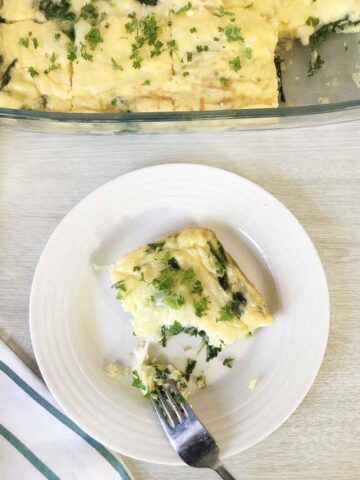 Cut a slice of the crustless spinach quiche with fork.