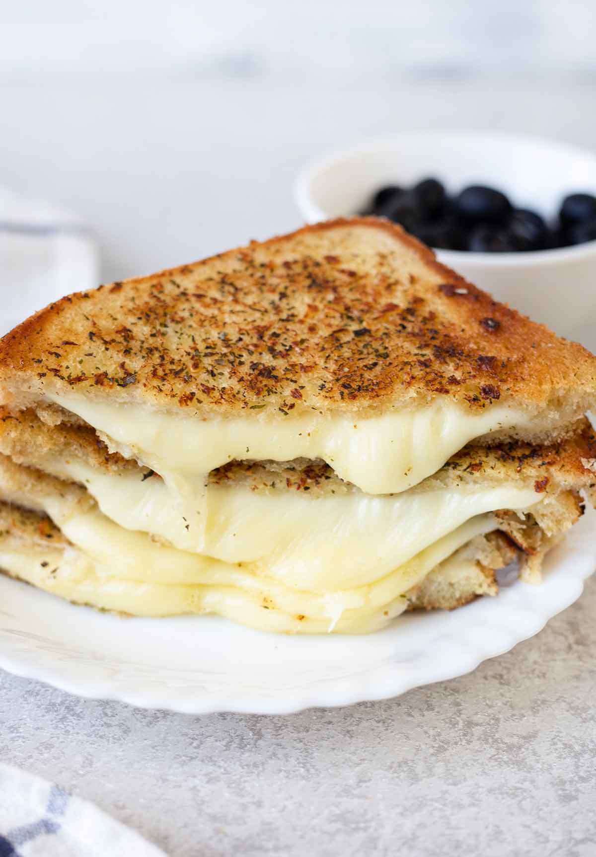 ooey-gooey melted cheese comes out of the grilled cheese sandwich.
