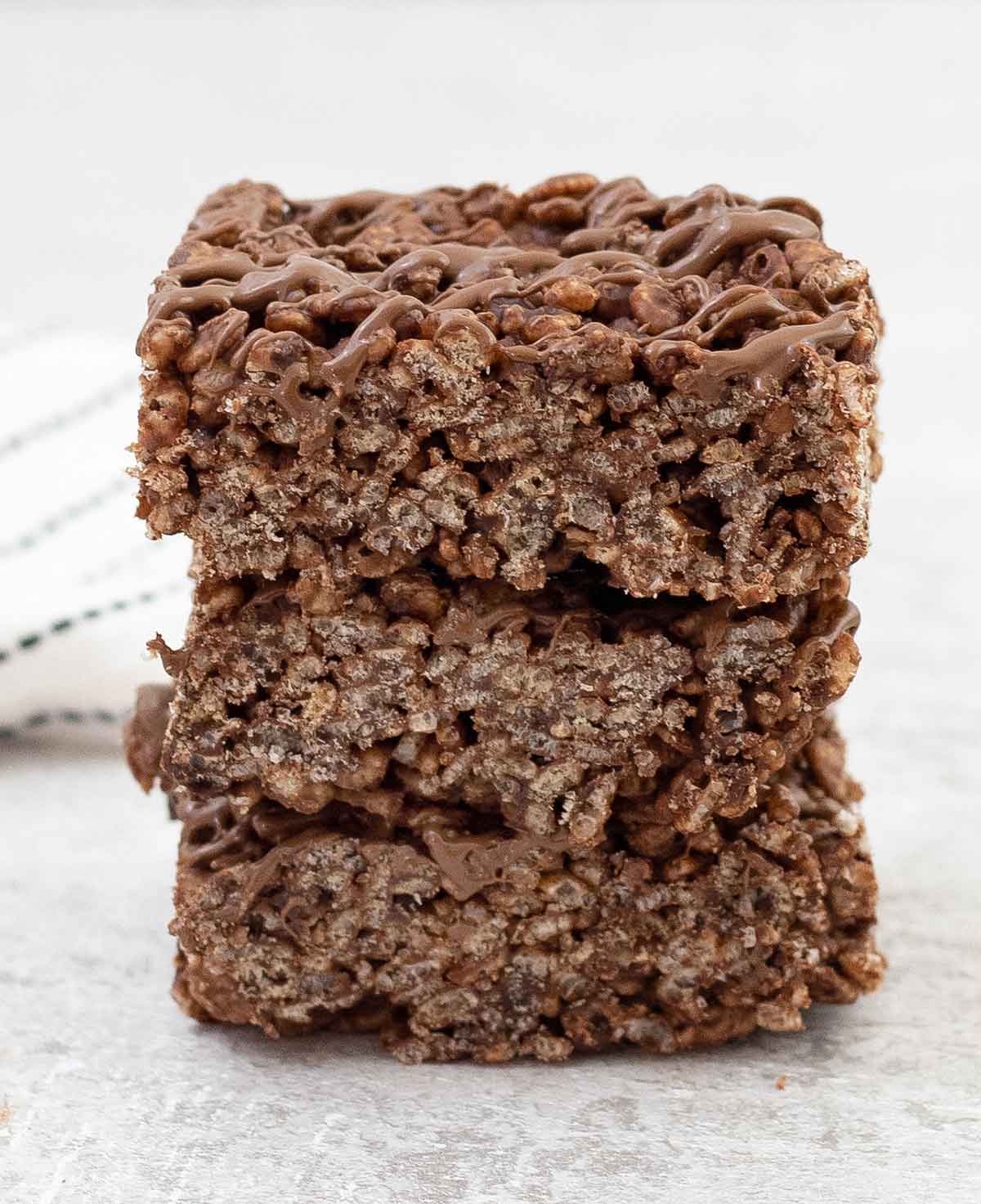 Chocolate rice krispie treats cut into squares and toped on each others.