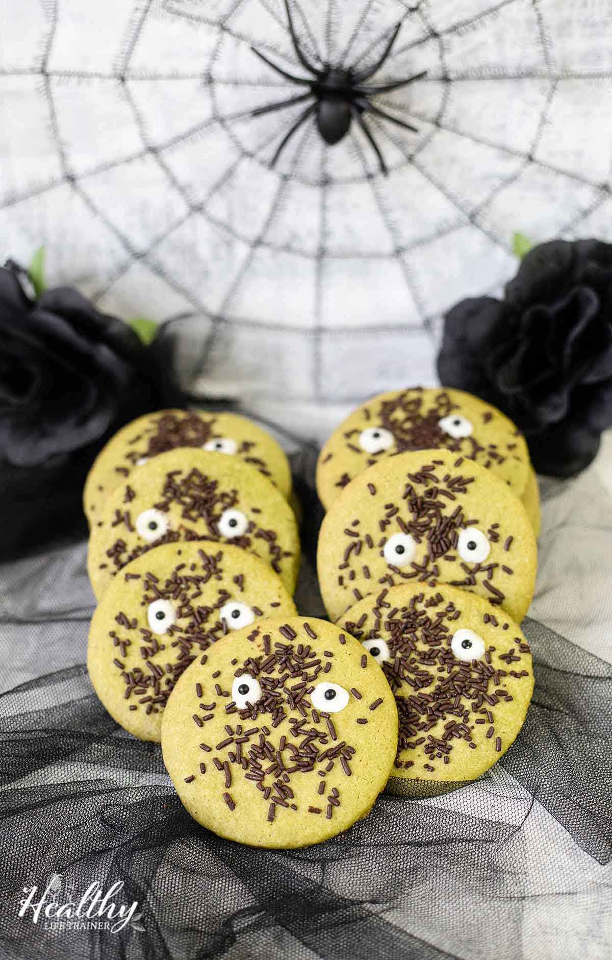 Cute halloween cookies with matcha, candy eyes and chocolate sprinkles.