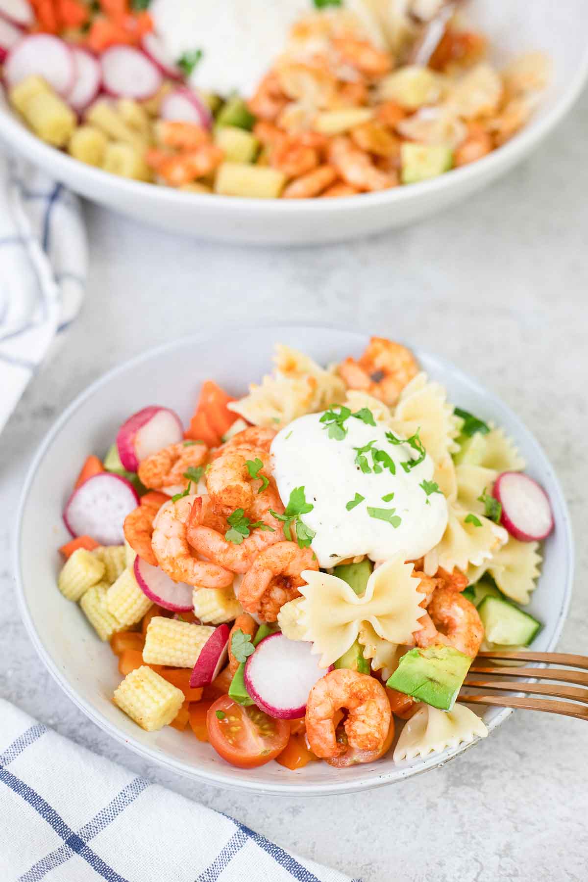 Italian shrimp pasta salad made with shrimp, avocado, corn and topped with a homemade creamy dressing.