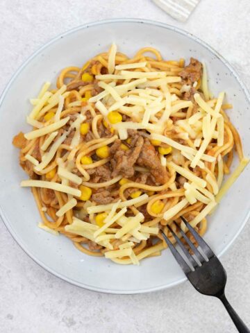 A serving plate full of Mexican taco spaghetti.