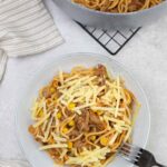 Mexican Spaghetti with ground beef topped with cheese.