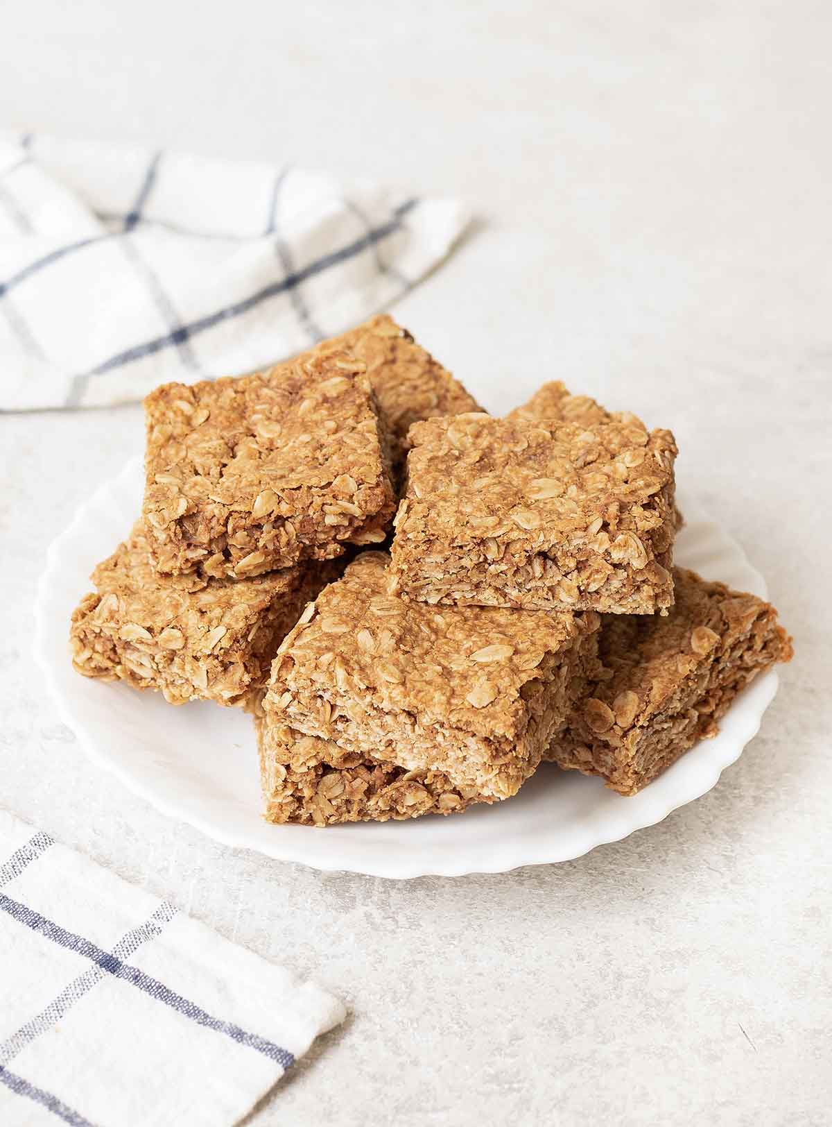 a serving plate filled with peanut butter flapjacks bars.