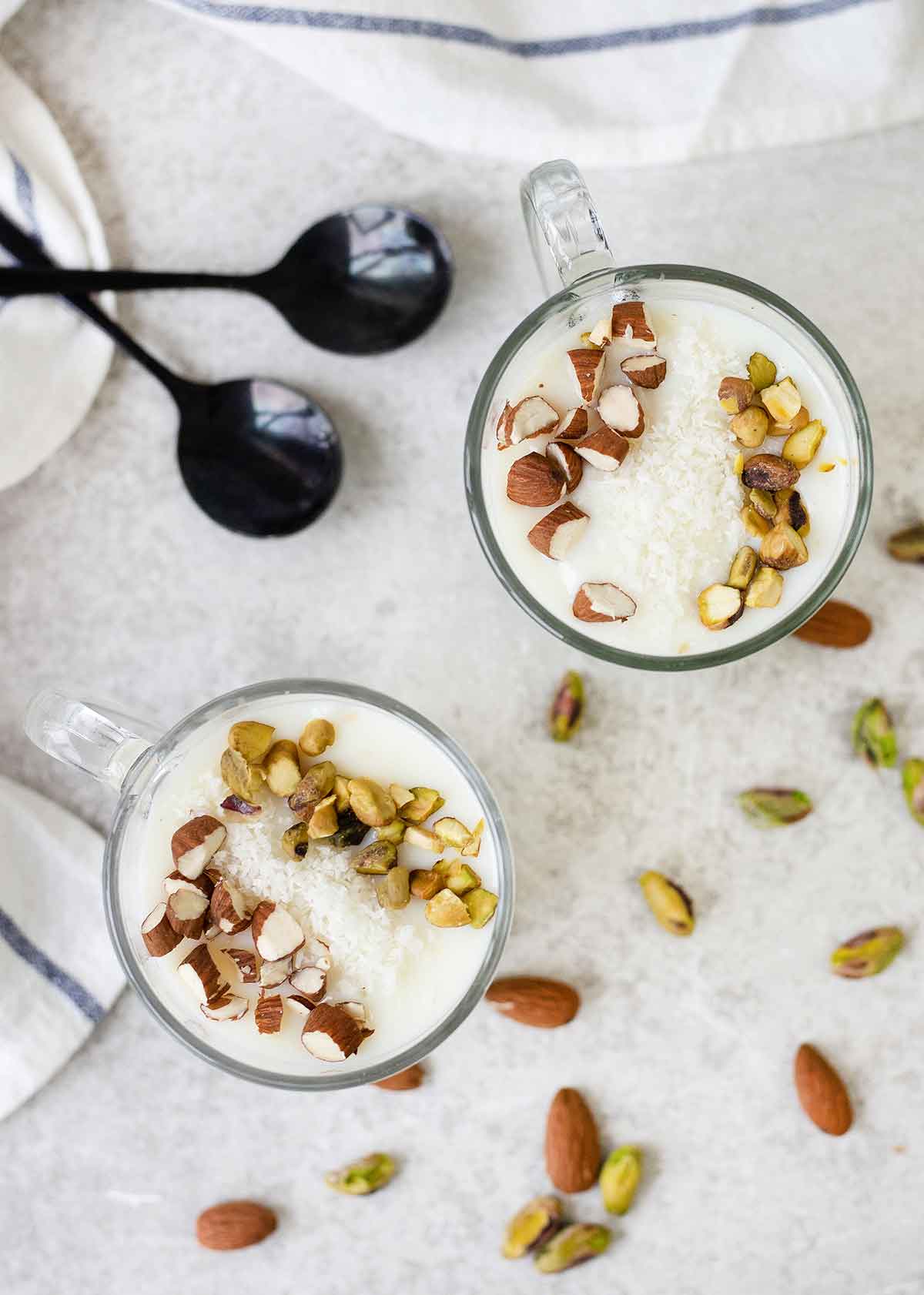 Middle Eastern sweet milk pudding (Sahlab) in a cup topped with nuts.