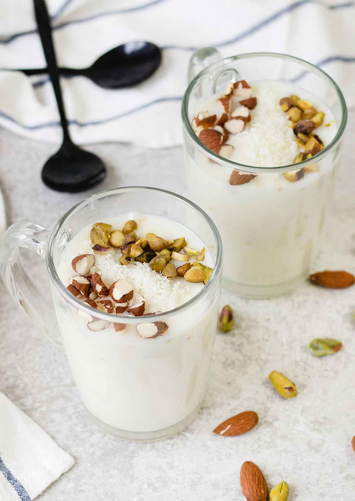 Sahlab in 2 cups topped with chopped almond, pistachio and coconut.