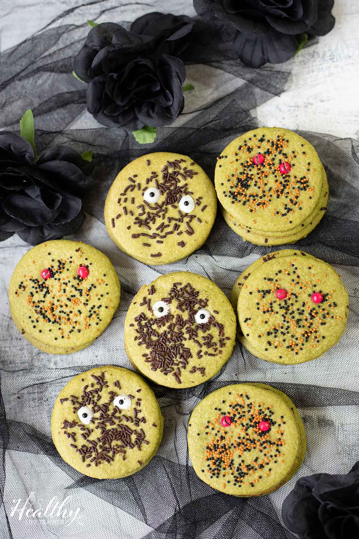 simple halloween cookies decorated with sprinkles, chocolate and candy eyes.