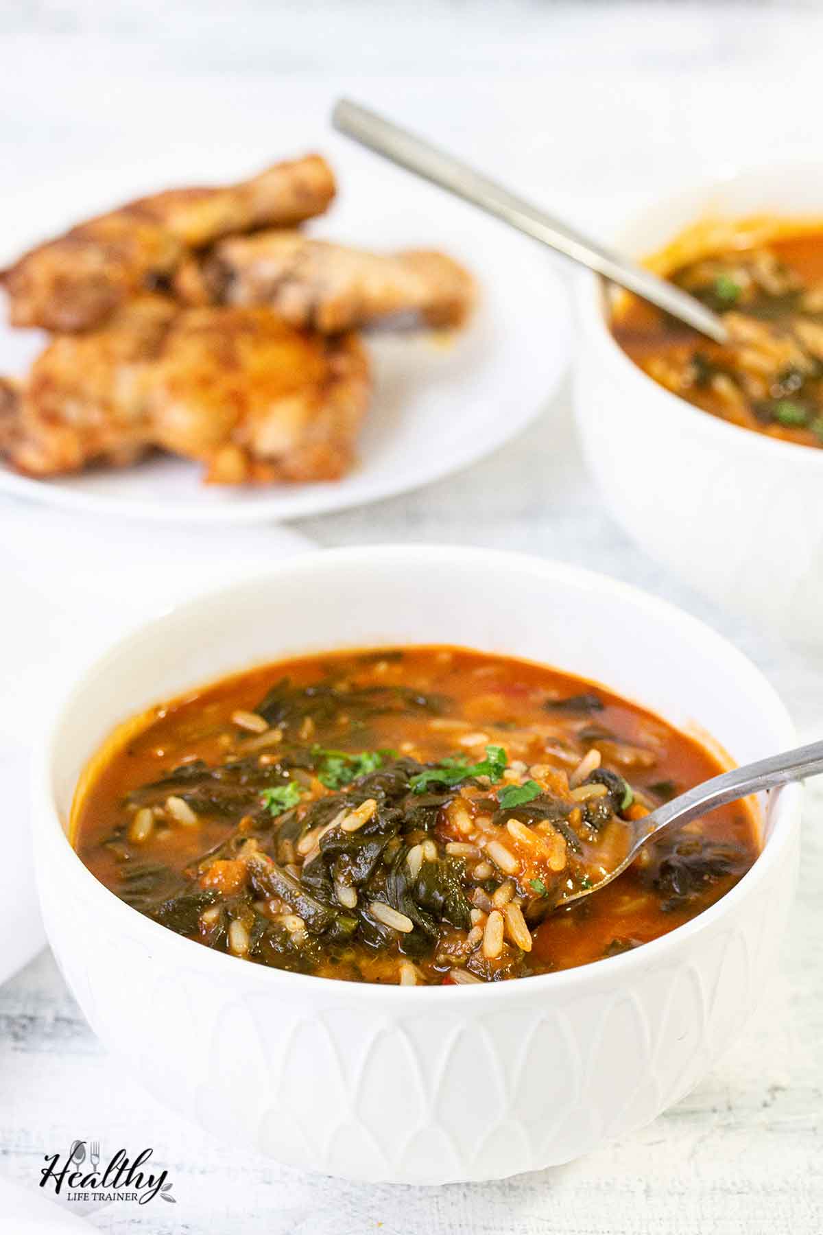 A bowl filled with African spinach stew with rice.