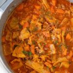 A large pot filled with cabbage roll soup.