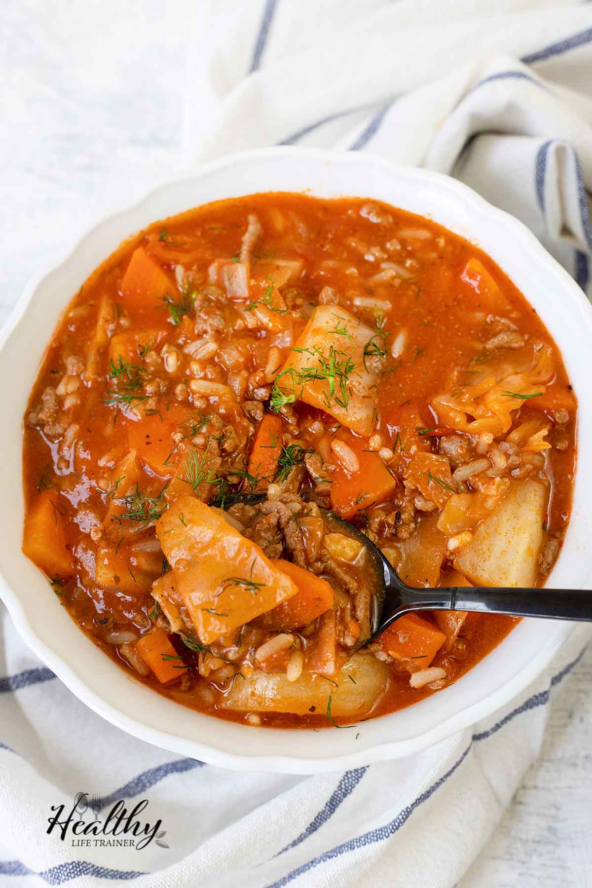 A spoonful of cabbage roll soup from a bowl.