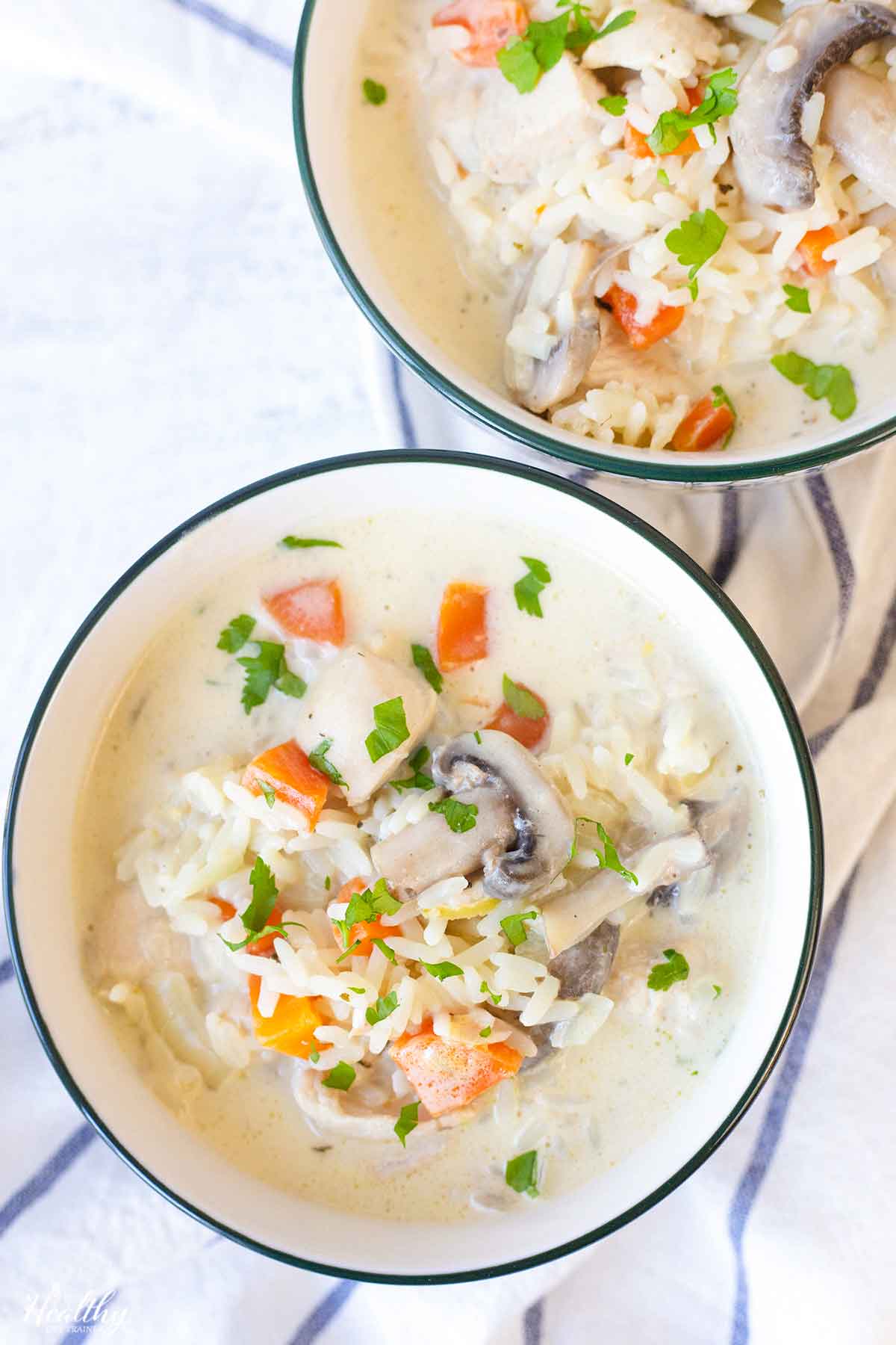 A bowl of creamy chicken and rice soup.