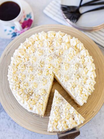 Eggnog cheesecake topped with a layer of eggnog whipped cream.