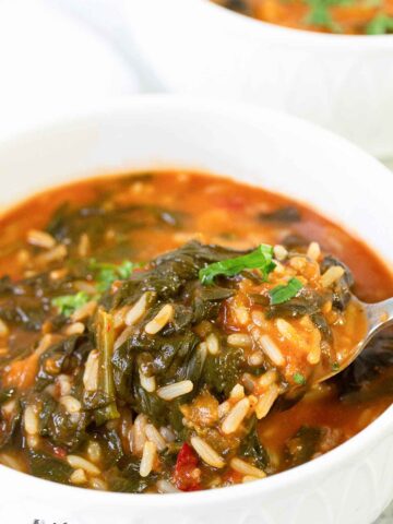 A spoonful of African spinach stew with rice.