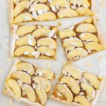 puff pastry crust filled with apple curd and topped with apple slices.