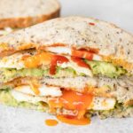 Avocado Egg Sandwich cut into halves.