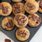 Nutella swirl banana Muffins in a muffin tin.