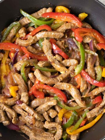 Black Pepper Beef Stir Fry with bell pepper and onion slices.