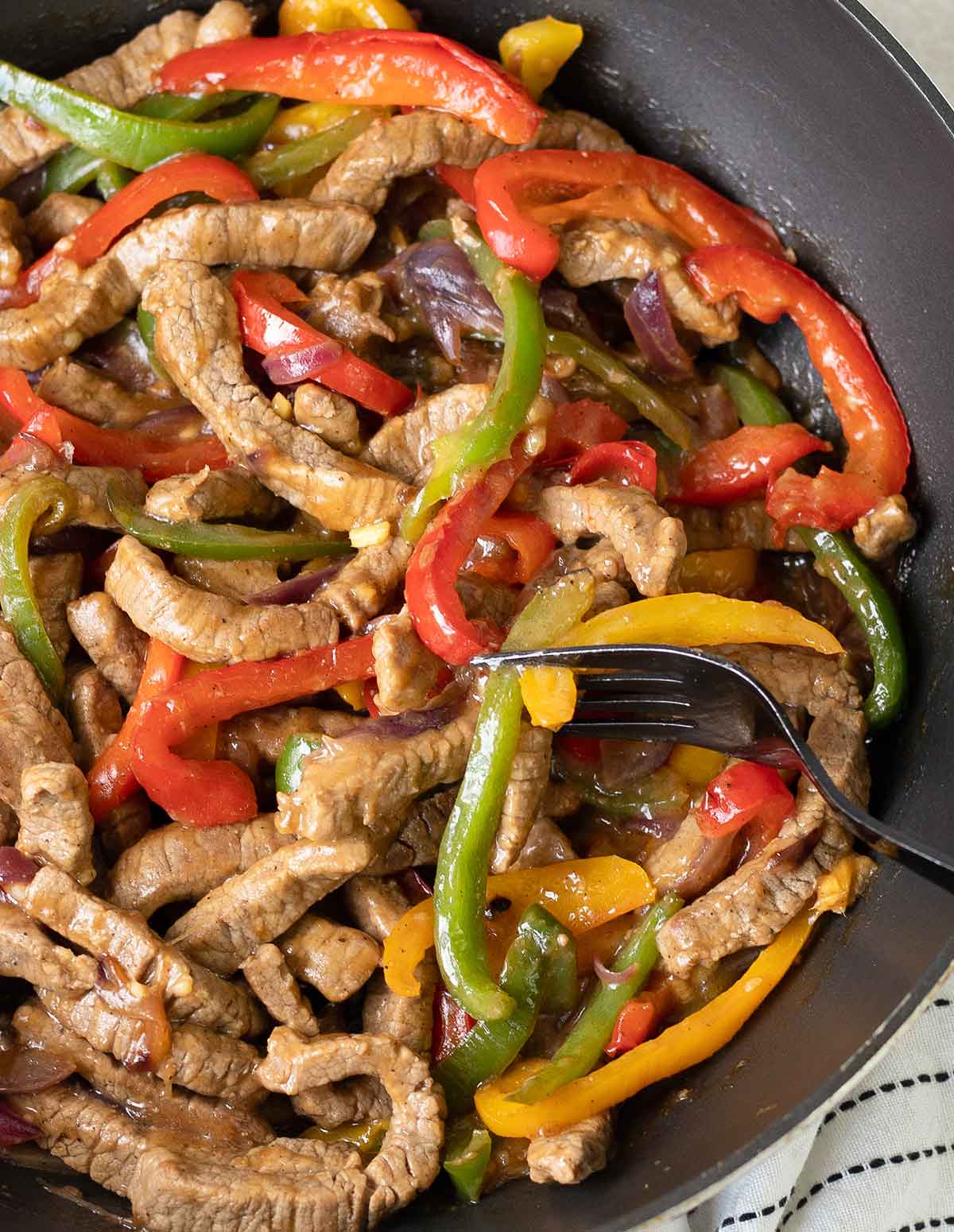 Black Pepper Beef Stir Fry with bell pepper and onion slices.