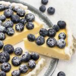 Blueberry custard tart topped with fresh blueberries.