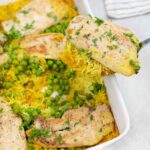 Chicken and Yellow Rice with peas in a casserole pan.