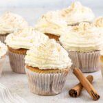 Cinnamon Cupcakes topped with whipped cream.