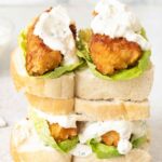 Fish Finger Sandwich with lettuce and sour cream sauce.