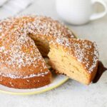 Golden Syrup Cake slice topped with shredded coconut.