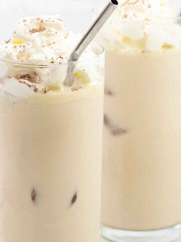 Iced White Chocolate Mocha in 2 glasses topped with whipped cream.