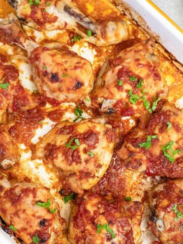 baked bbq chicken legs in a baking pan.