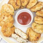 fish patties and a small bowl of ketchup.