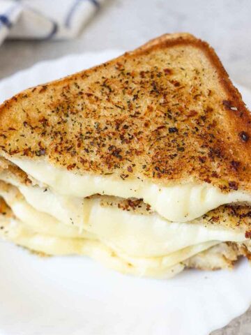 ooey-gooey melted cheese come out of the garlic bread grilled cheese.
