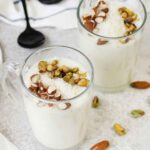 Sahlab in a glass topped with nuts.