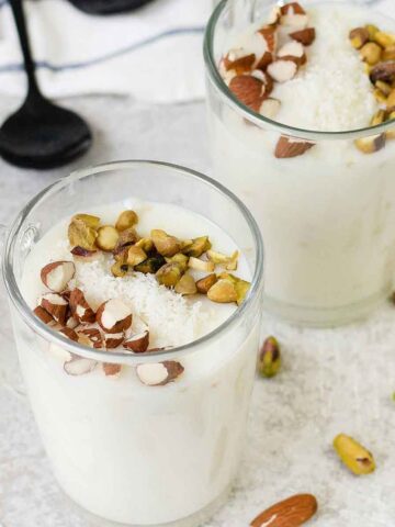 Sahlab in a glass topped with nuts.