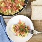 scrambled eggs with smoked salmon in a serving plate.