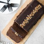 Coffee Loaf Cake topped with chocolate glaze and chopped walnuts.