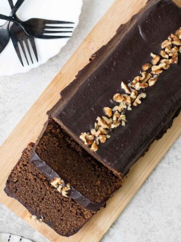 Coffee Loaf Cake topped with chocolate glaze and chopped walnuts.