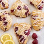 Lemon Raspberry Scones and 2 slices of lemon along with fresh raspberries.