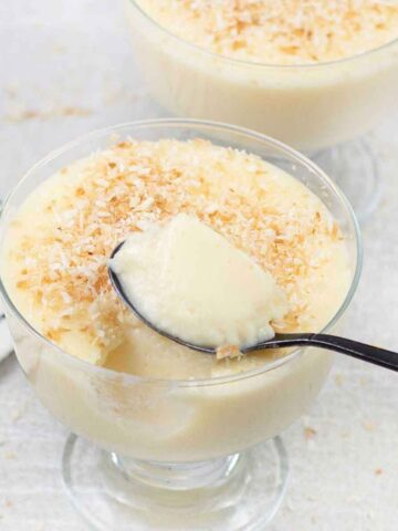 coconut milk pudding topped with toasted shredded coconut.