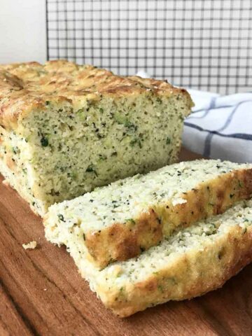 keto zucchini bread cut on a chopping board.