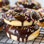 Homemade Baked Donuts topped with chocolate glaze and sprinkles.