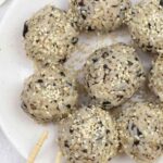 seaweed rice balls and chopsticks on a serving plate.